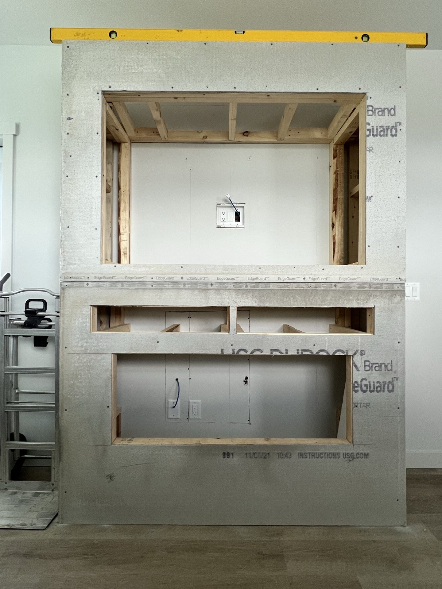 Cement board backer installed over the fireplace framing