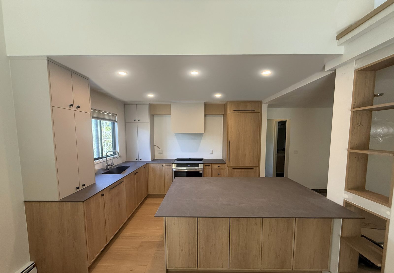 Finished custom kitchen with island and hardwood floors by Dondero Construction and Renovation